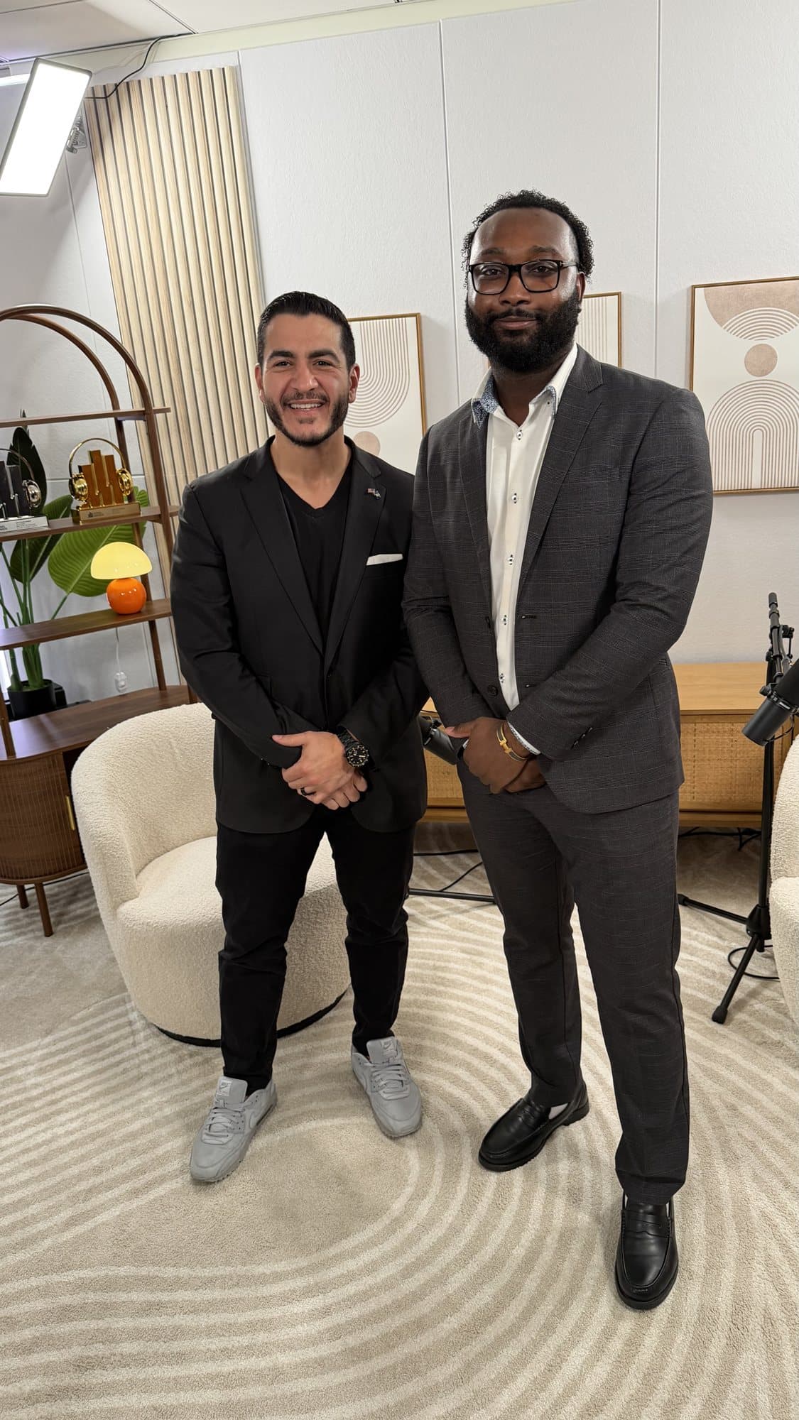 Brian Allen standing with Dr. Abdul El-Sayed in the podcast studio