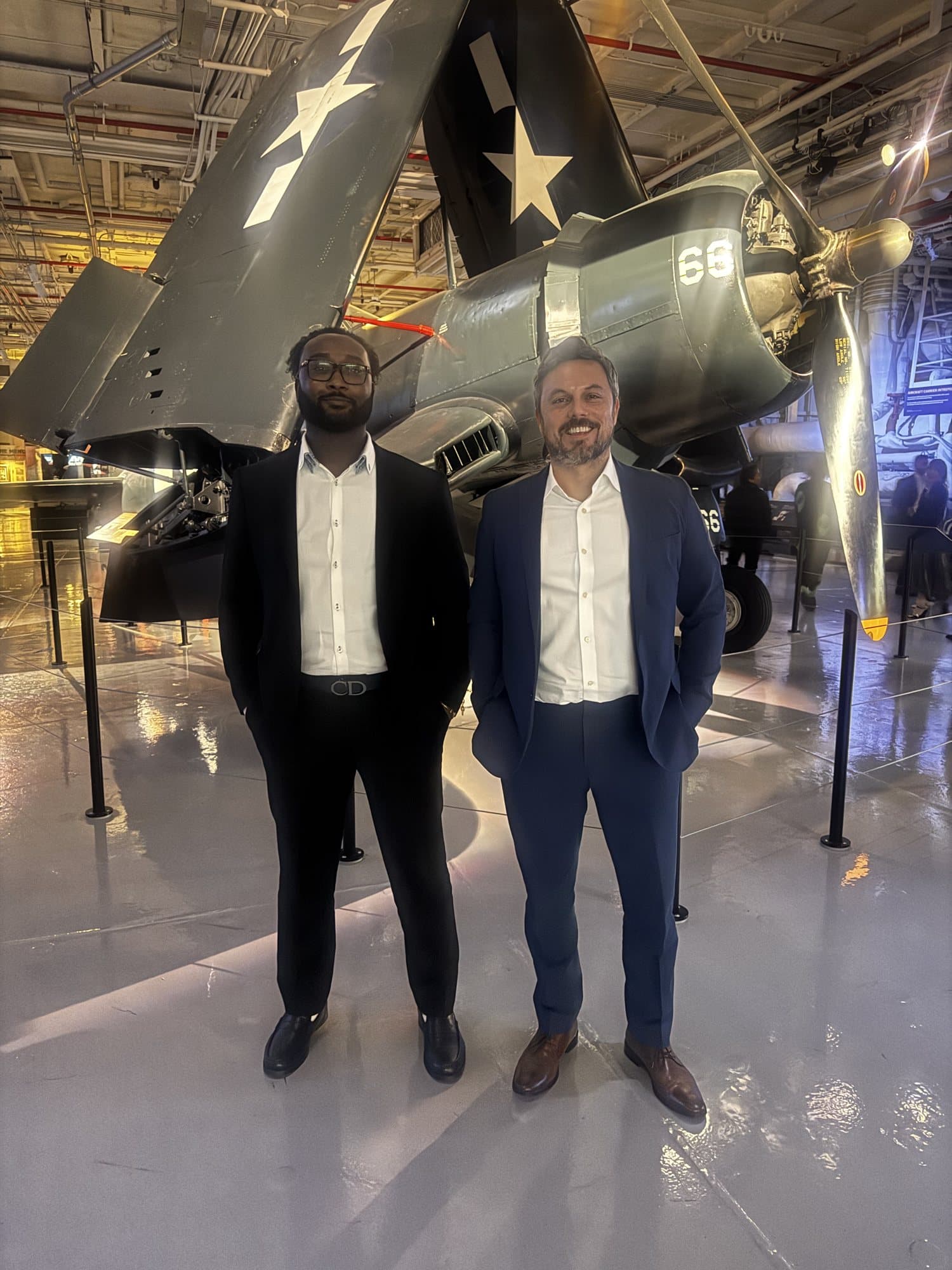 Brian Allen with filmmaker Dan Farah in front of a vintage aircraft